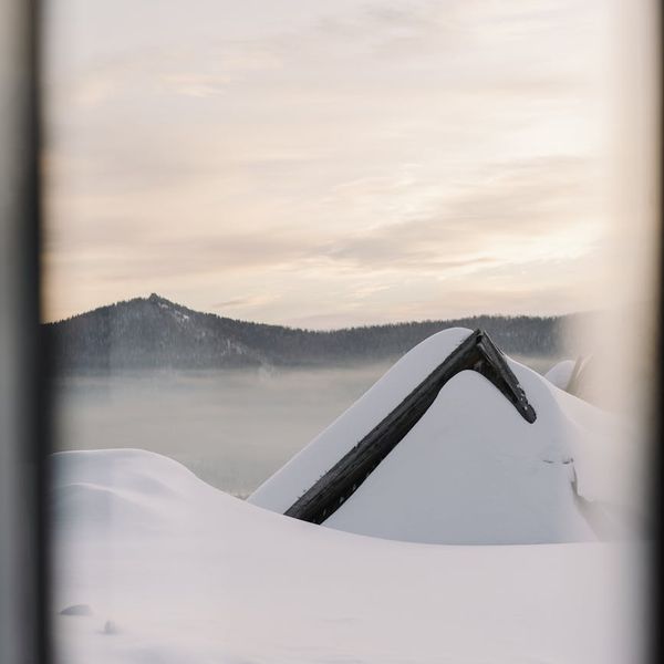 Silhouette of a person meditating peacefully during sunrise.